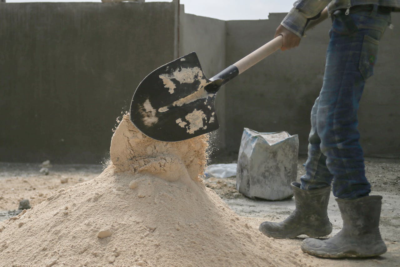 A laborer shoveling sand at a construction site in Latakia, Syria.